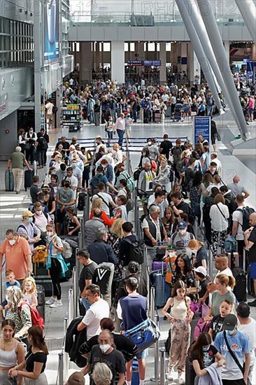 Passengers waiting for check-in in front of the check-in counter