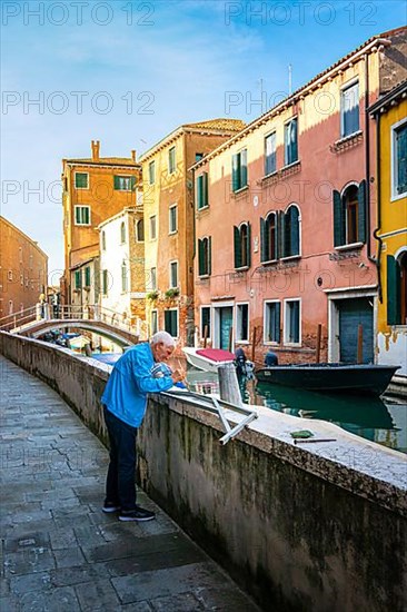 Senior doing handicraft work in the lagoon city of Venice