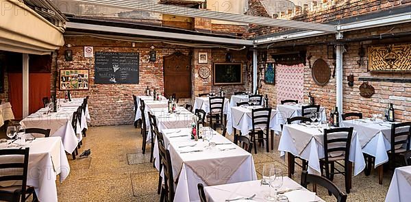 Restaurant in the courtyard of a residential building in the lagoon city of Venice