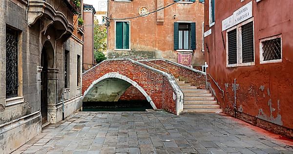 Stone Bridge and Venetian House Facades in the Lagoon City of Venice