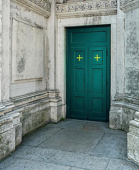 Green door at the side entrance of the church of Santa Maria della Salute