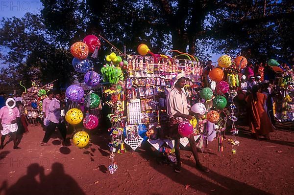 A traditional balloon vendor selling balloons during Anthimahakalan Kavu festival