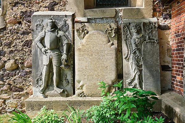 Figure gravestone and sandstone epitaph with angel figure