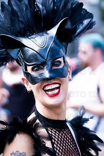 Costumed laughing woman from the SM scene