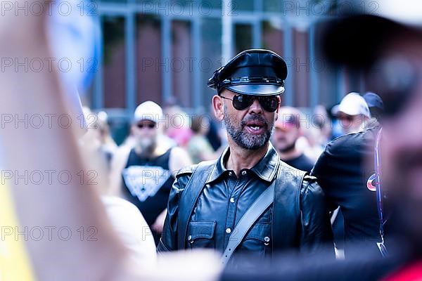 Homosexual men from the SM scene in martial leather clothing at the CSD parade