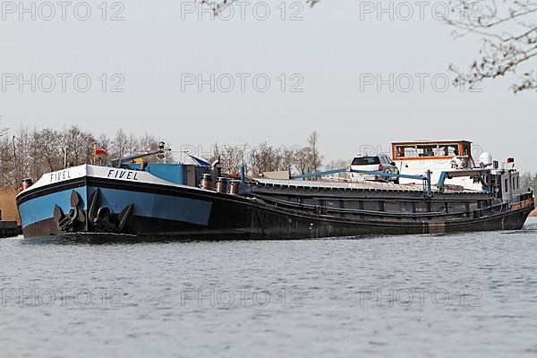 Fully loaded Dutch cargo ship Fivel on the river Peene