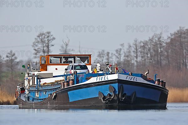 Fully loaded Dutch cargo ship Fivel on the river Peene