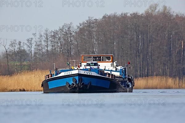 Fully loaded Dutch cargo ship Fivel on the river Peene