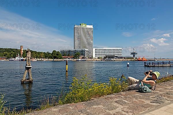 Woman lying on the ground and taking pictures