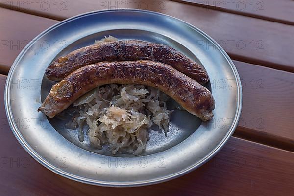 Pewter plate with two Franconian sausages and sauerkraut