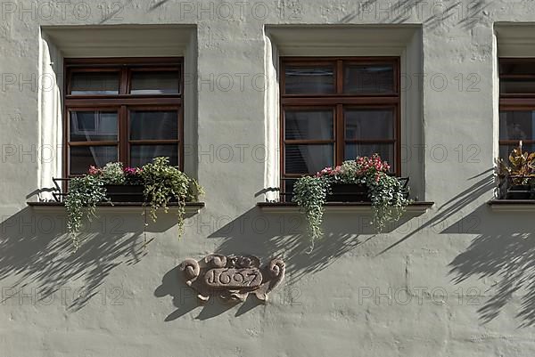 Window with year of construction 1697 on historic residential and commercial building