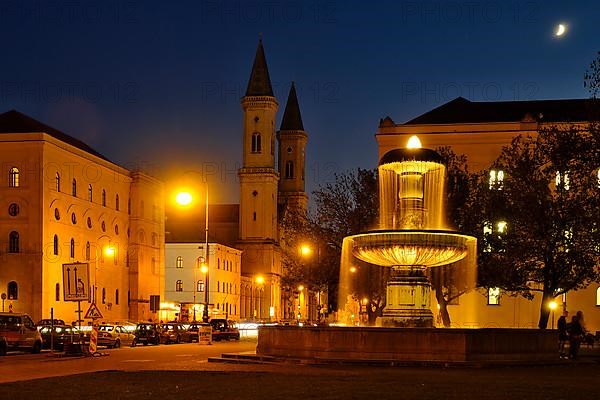 Illuminated fountain of the University and Church of St. Ludwig