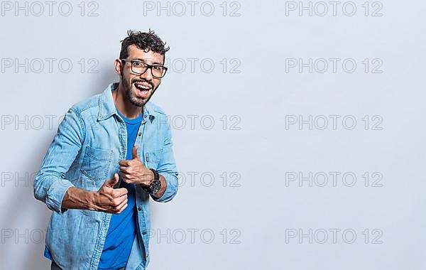 Handsome man with thumbs up doing ok