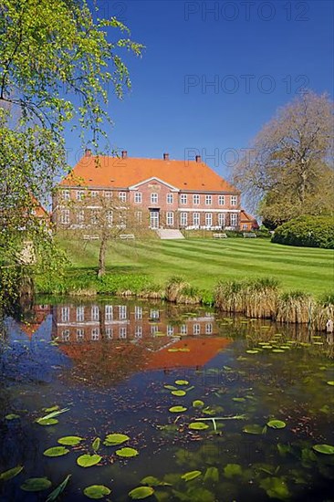 Manor house reflected in a pond