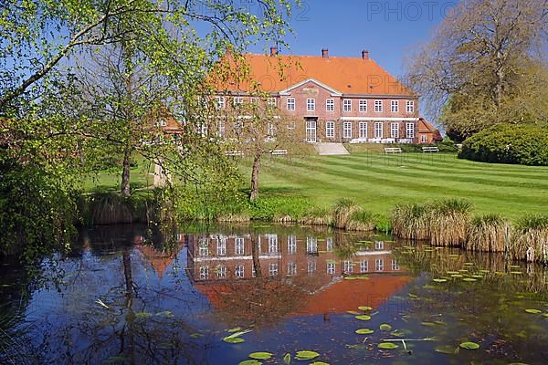 Manor house reflected in a pond