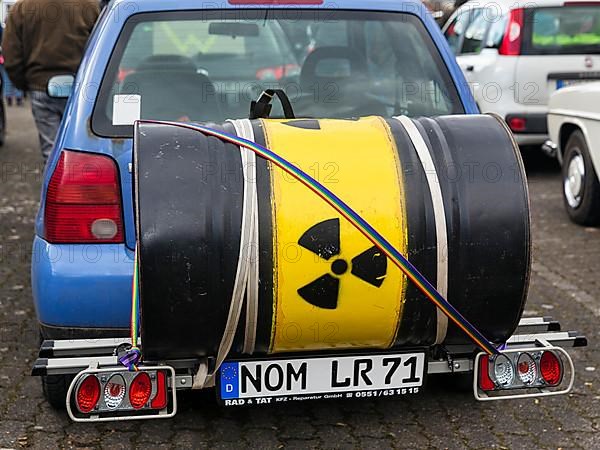 Metal barrel with sign for radioactivity on bicycle rack