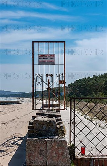 Old firewall with rusty fences on the beach of Prora