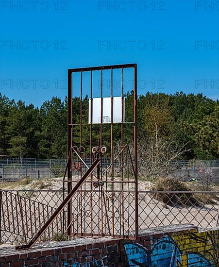 Old firewall with rusty fences on the beach of Prora