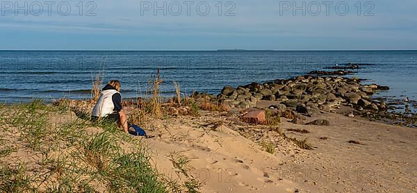 Holidaymaker relaxing on the beach of the Baltic Sea