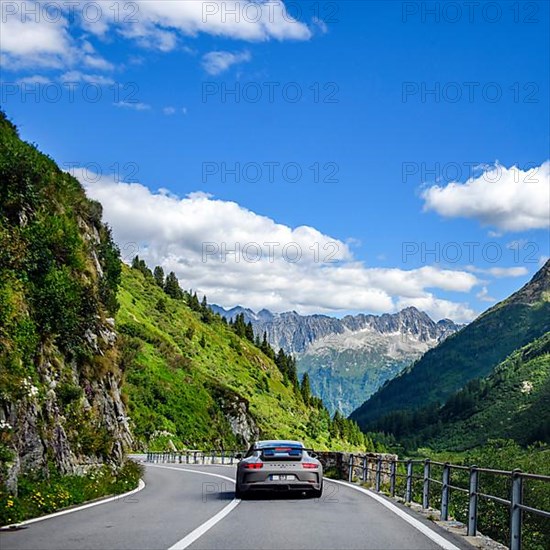 Supercar sports car GT3 driving on road from Sustenpass to Wassen