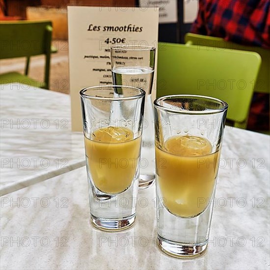 Two glasses of Pastis with ice on a table in the restaurant