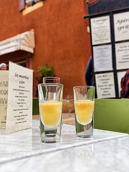 Two glasses of Pastis with ice on a table in the restaurant