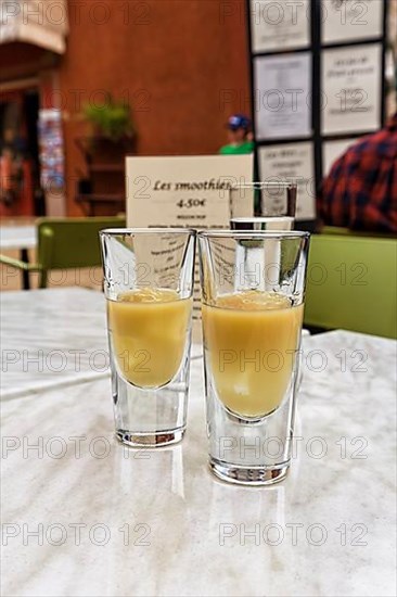 Two glasses of Pastis with ice on a table in the restaurant