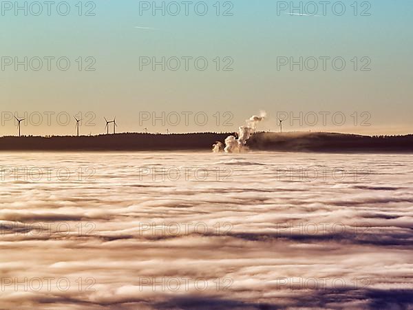 Three columns of steam rising from cloud cover