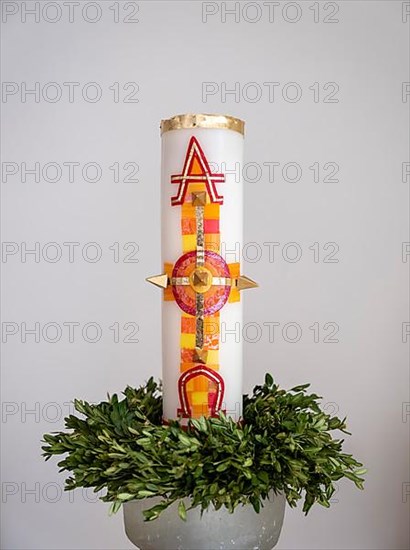 Large candle with alpha and omega signs in Germany's first private ecumenical motorway church 'Geiselwind Licht auf unserem Weg' on the A 3 between Wuerzburg and Nuremberg