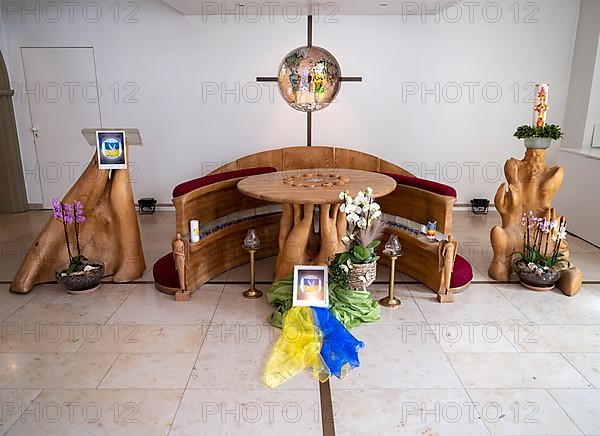 Picture with peace dove and flag of Ukraine on silk cloths in the Ukrainian national colours blue and yellow in the chancel of Germany's first private ecumenical motorway church Geiselwind Light on our way on the A 3 between Wuerzburg and Nuremberg