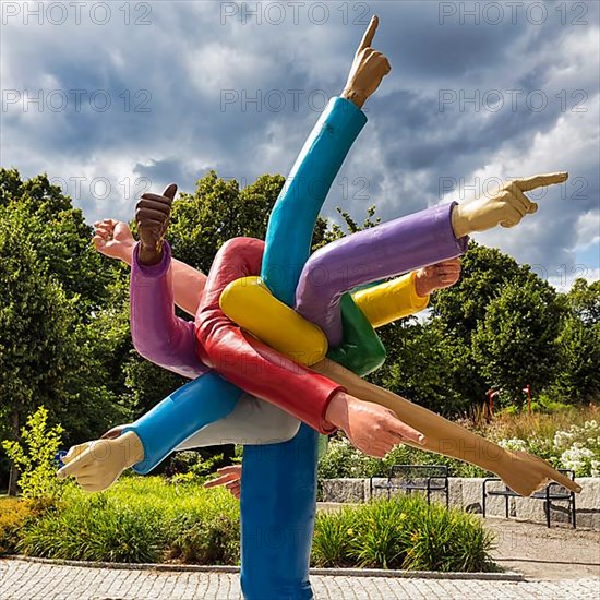 Many colourful arms pointing in different directions with outstretched index finger