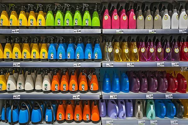 Shelf with spray bottles and watering cans