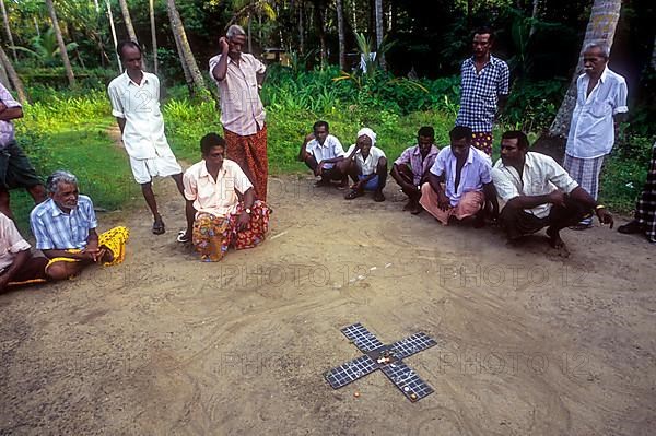 Village men playing dice game Pakida kali in Kodungallur
