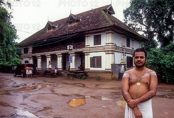 Nambudiri Priest standing in front of Pambummekkatu Mana Nagaraja Temple