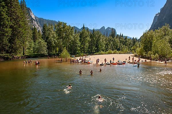 Tourists bathing in the Merced River in Yosemite National Park