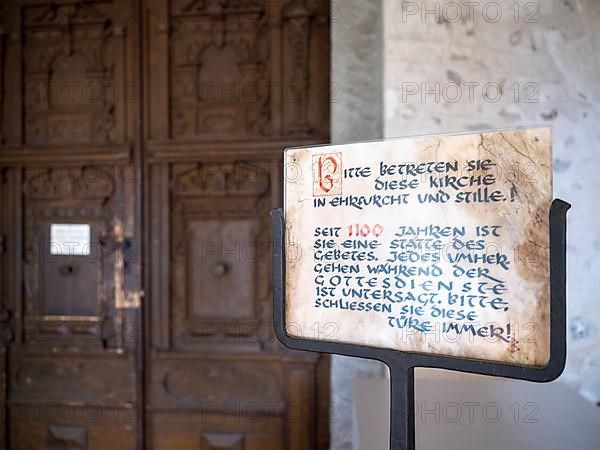 Sign in front of the portal of the Catholic parish church of St. George