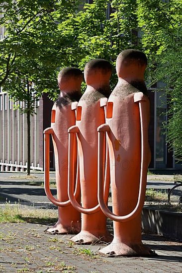 Three human petrol pumps refuelling themselves