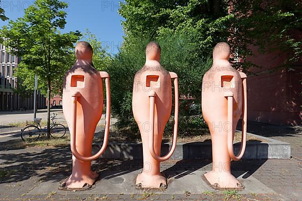 Three human petrol pumps refuelling themselves