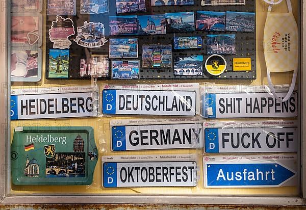 Signs and knick-knacks for tourists in a shop window of a shop in the old town of Heidelberg. The shop is closed due to the Corona pandemic