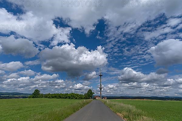 Transmission mast with cloudy sky
