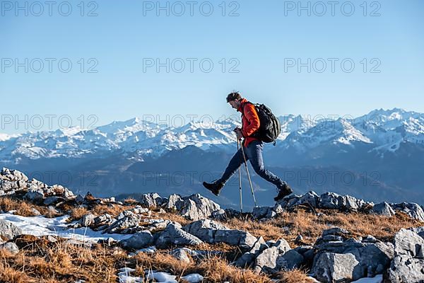 Mountaineer hiking in front of mountain panorama