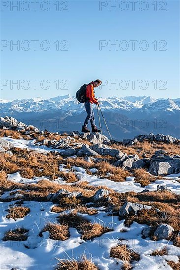 Mountaineer hiking in front of mountain panorama