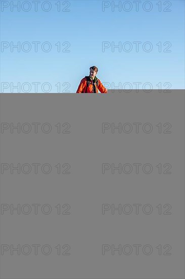 Mountaineer in front of mountain panorama