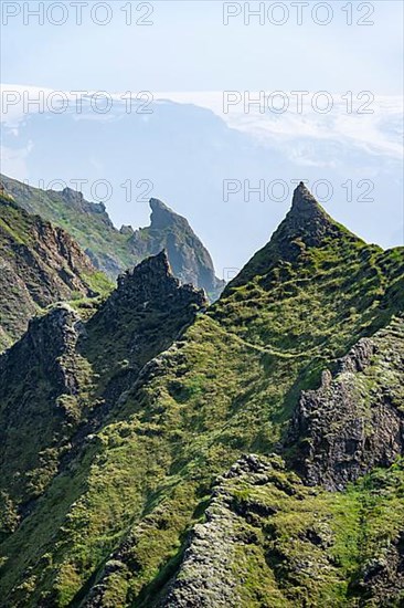 Pointed green mountain peaks on the ridge of Tindfjoell