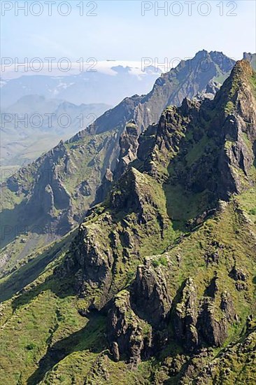 Pointed green mountain peaks on the ridge of Tindfjoell