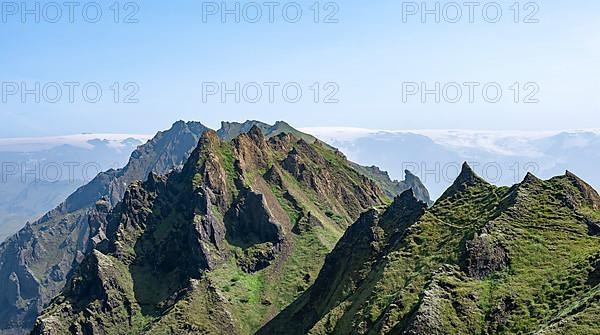 Pointed green mountain peaks on the ridge of Tindfjoell