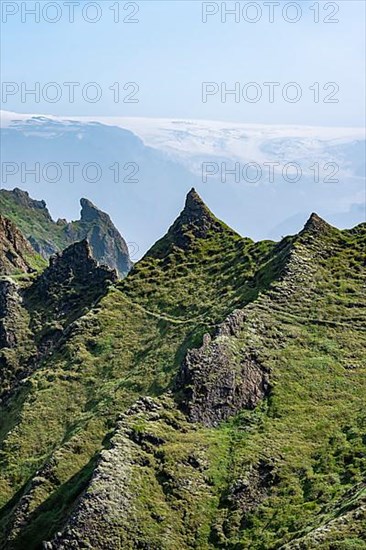 Pointed green mountain peaks on the ridge of Tindfjoell