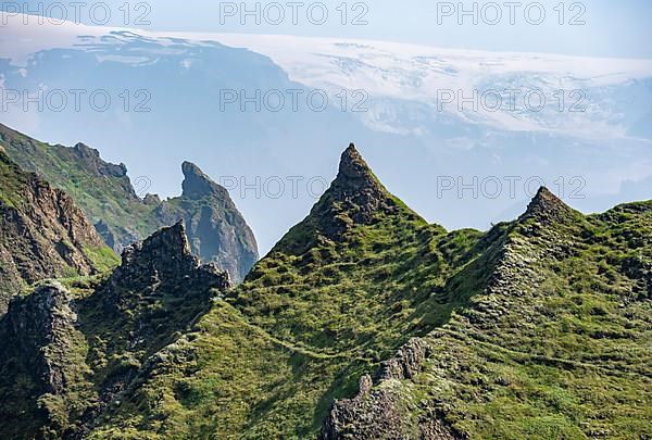 Pointed green mountain peaks on the ridge of Tindfjoell