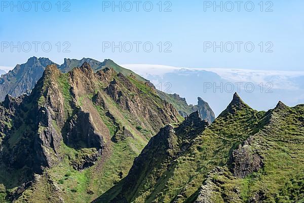 Pointed green mountain peaks on the ridge of Tindfjoell