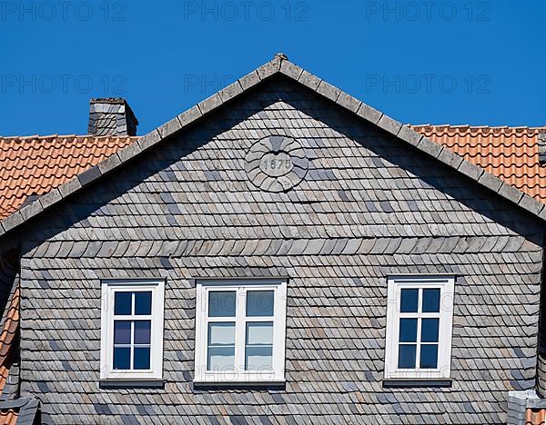 Facade covered with slate shingles of a former restaurant at the Auerhahnteich